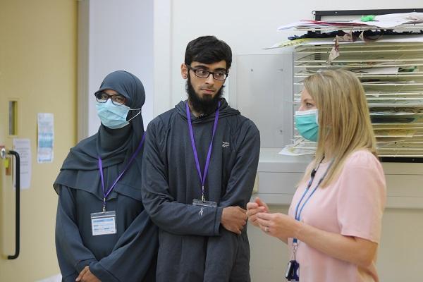 Abdullah stood with Melanie Burrough, Director of Therapies at The Children’s Trust 