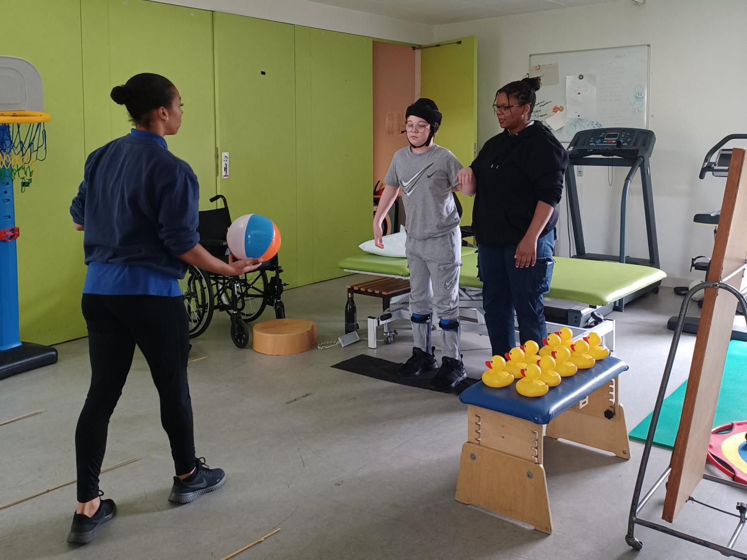 Riley being thrown a ball in a physiotherapy session