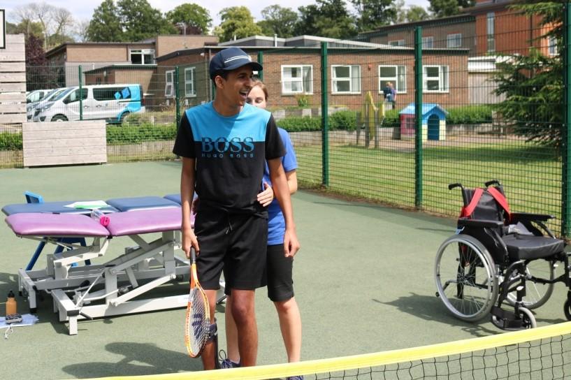 Zac playing tennis is a physiotherapy session