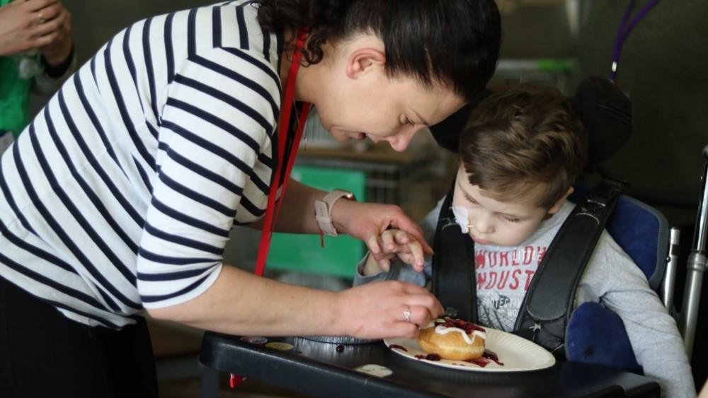 Gabriel decorating doughnuts for National Doughnut Week
