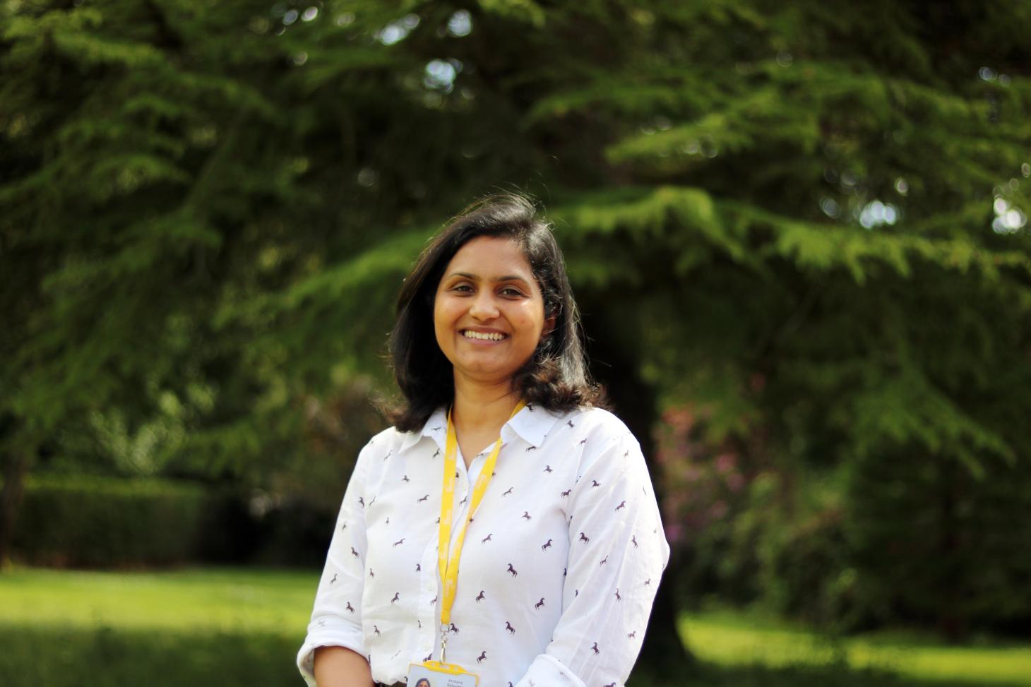 Volunteer standing outdoors smiling at the camera