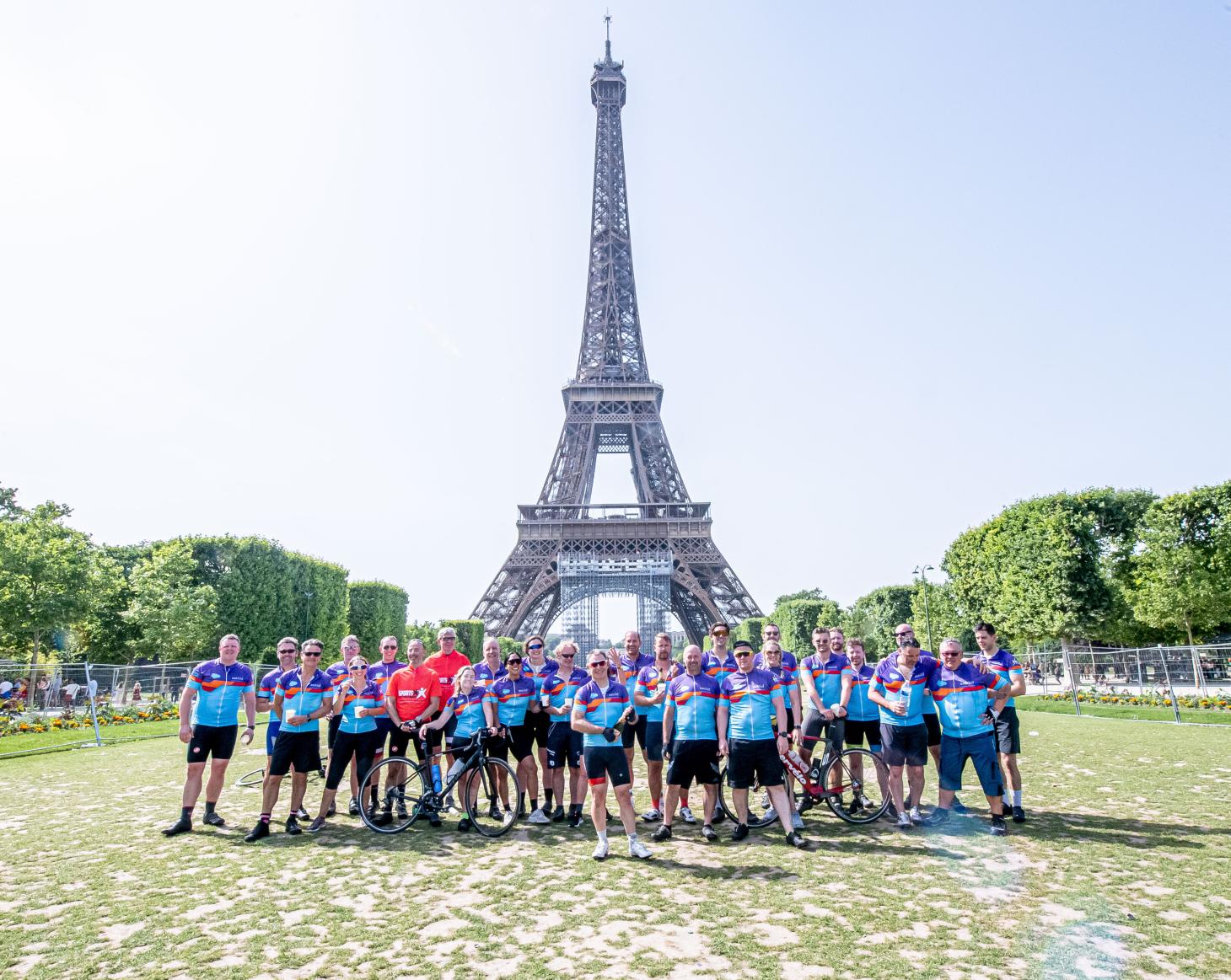 Cyclists stood Infront of the Eiffel tower 