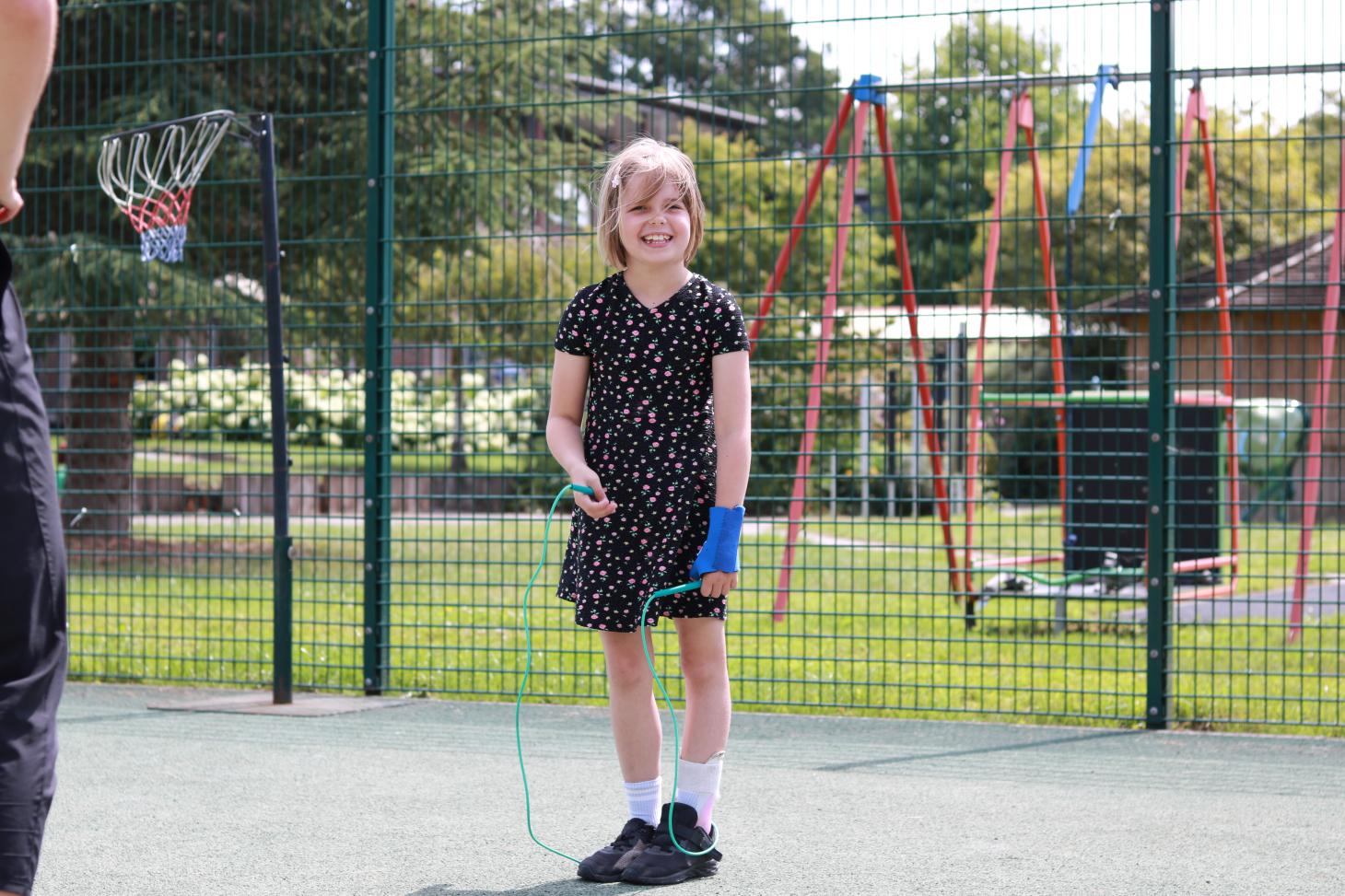 Marnie smiling at the camera holding a skipping rope