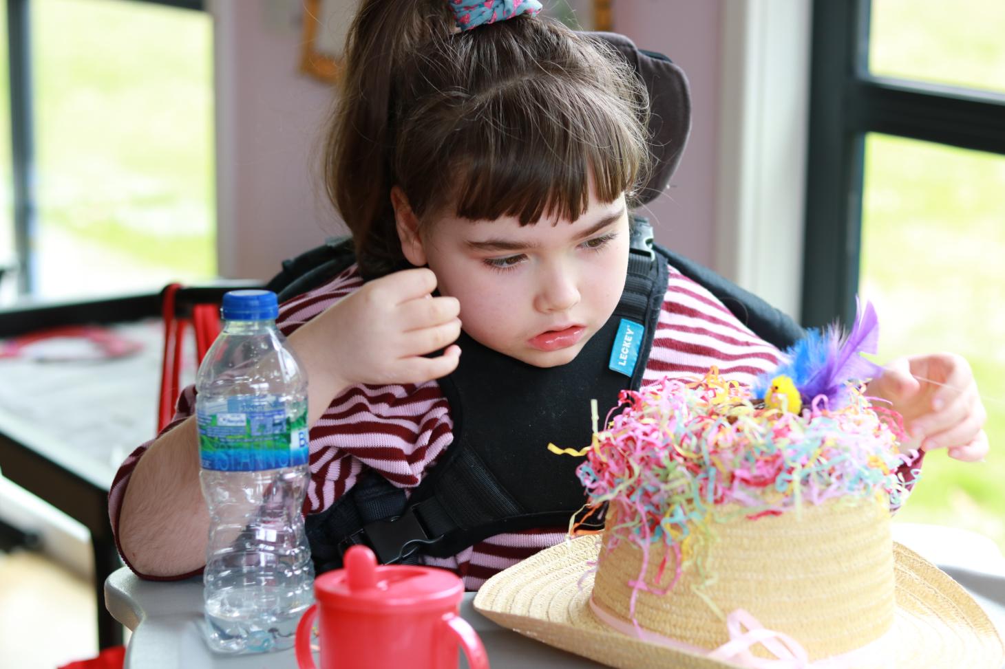 Child making an Easter bonnet