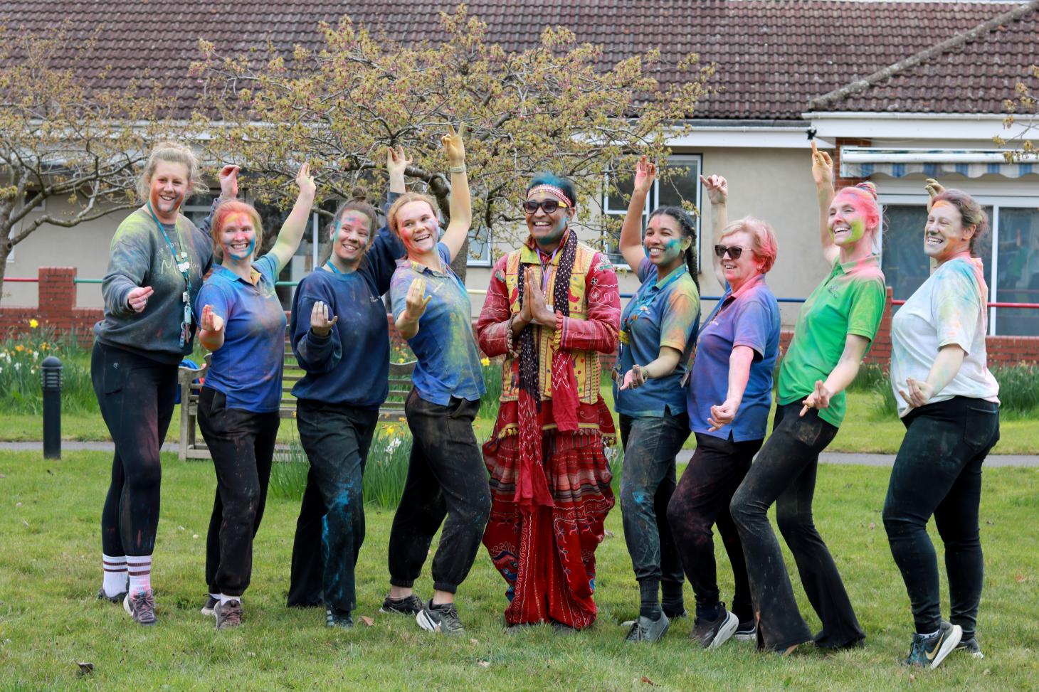 staff smiling and posing with dance instructor