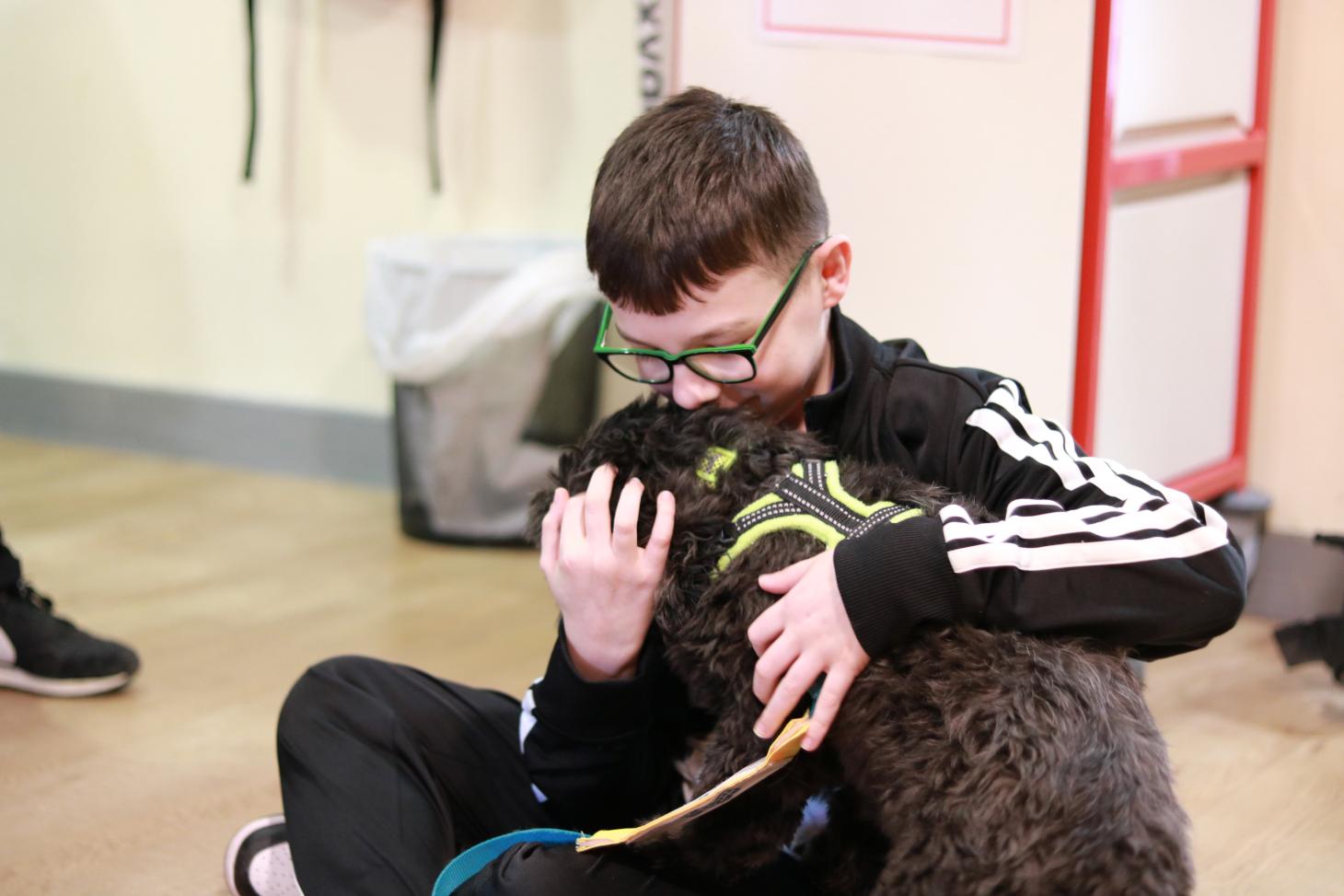 child cuddling a PAT dog