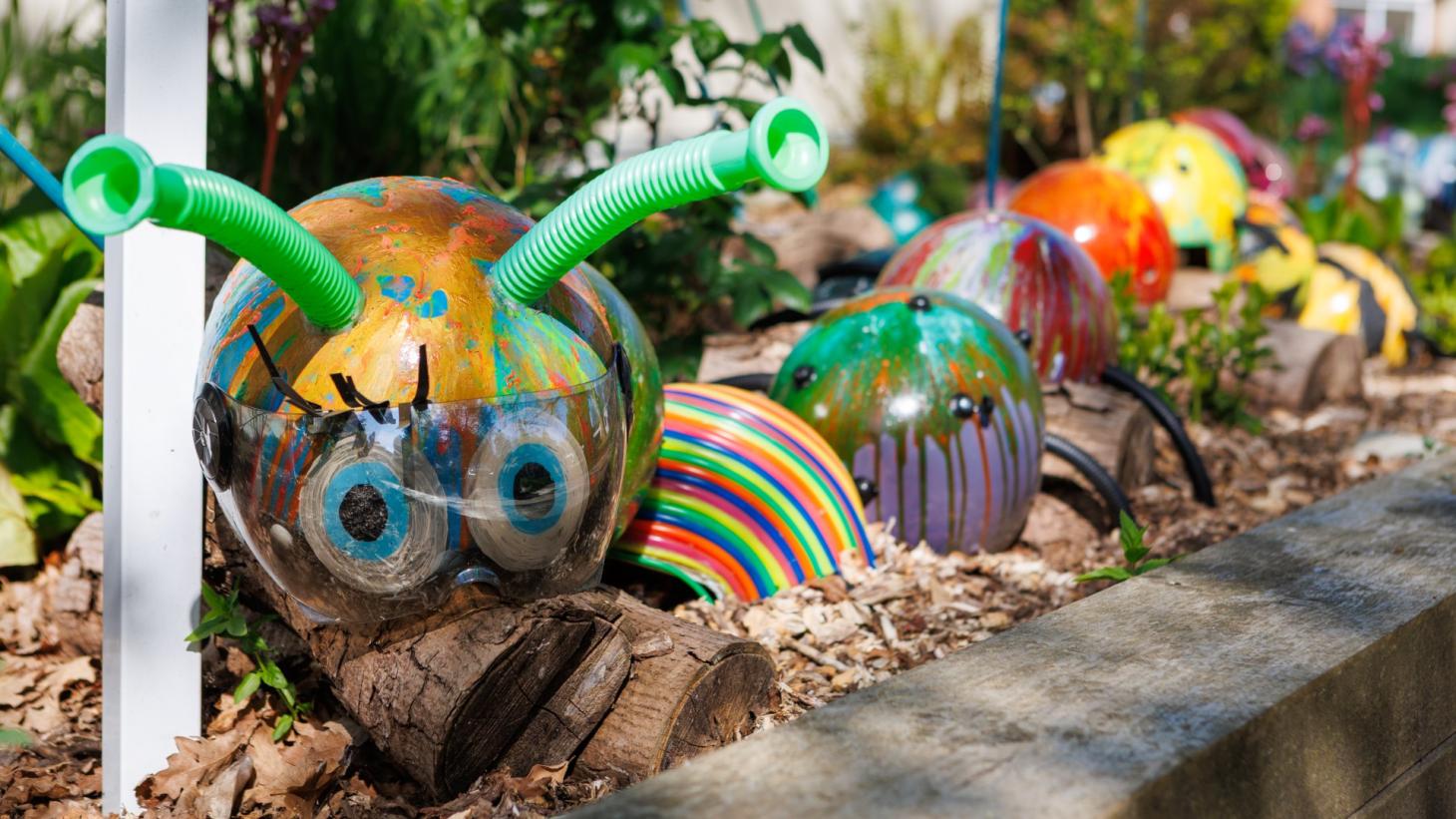 A caterpillar painted in bright colours by the school children.