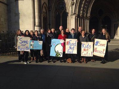 campaigners stand holding placards that read 'save our respite' and 'fund not fail' and 'kids not cutes' and 'save nascot'