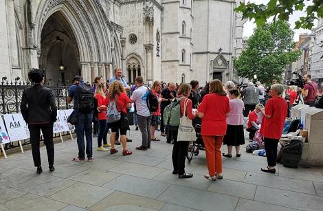 People stand around outside High Court