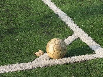 football on the corner of the pitch