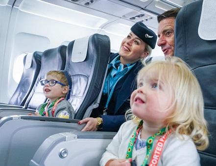 young children smile with cabin crew, image credit: Gatwick Airport