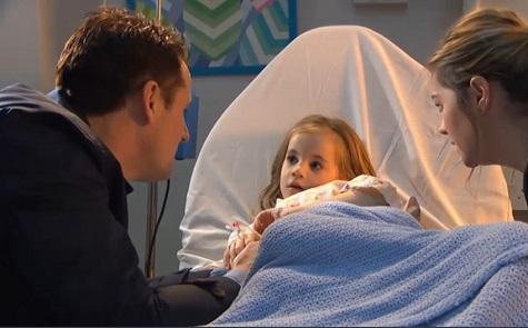 character in Hollyoaks is in a hospital bed 