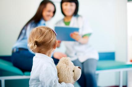 young girl looks at a doctor 