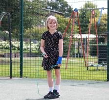 Marnie smiling at the camera holding a skipping rope