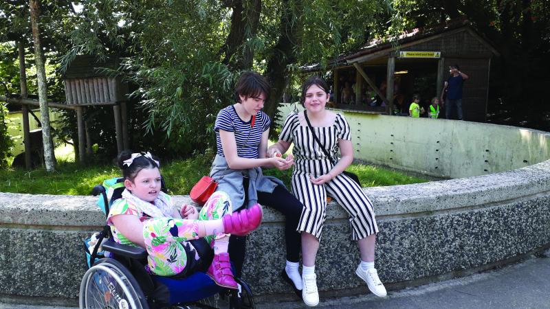 Chloe outside in her wheelchair