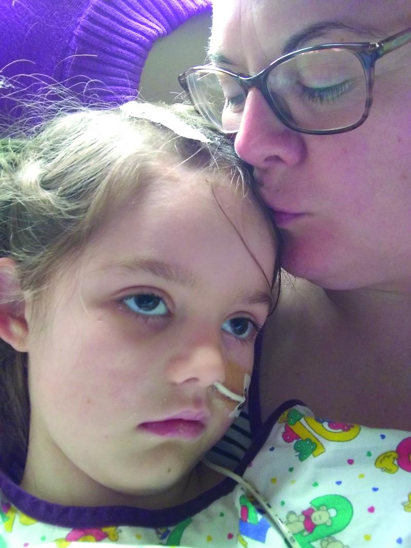 Emma in hospital with family