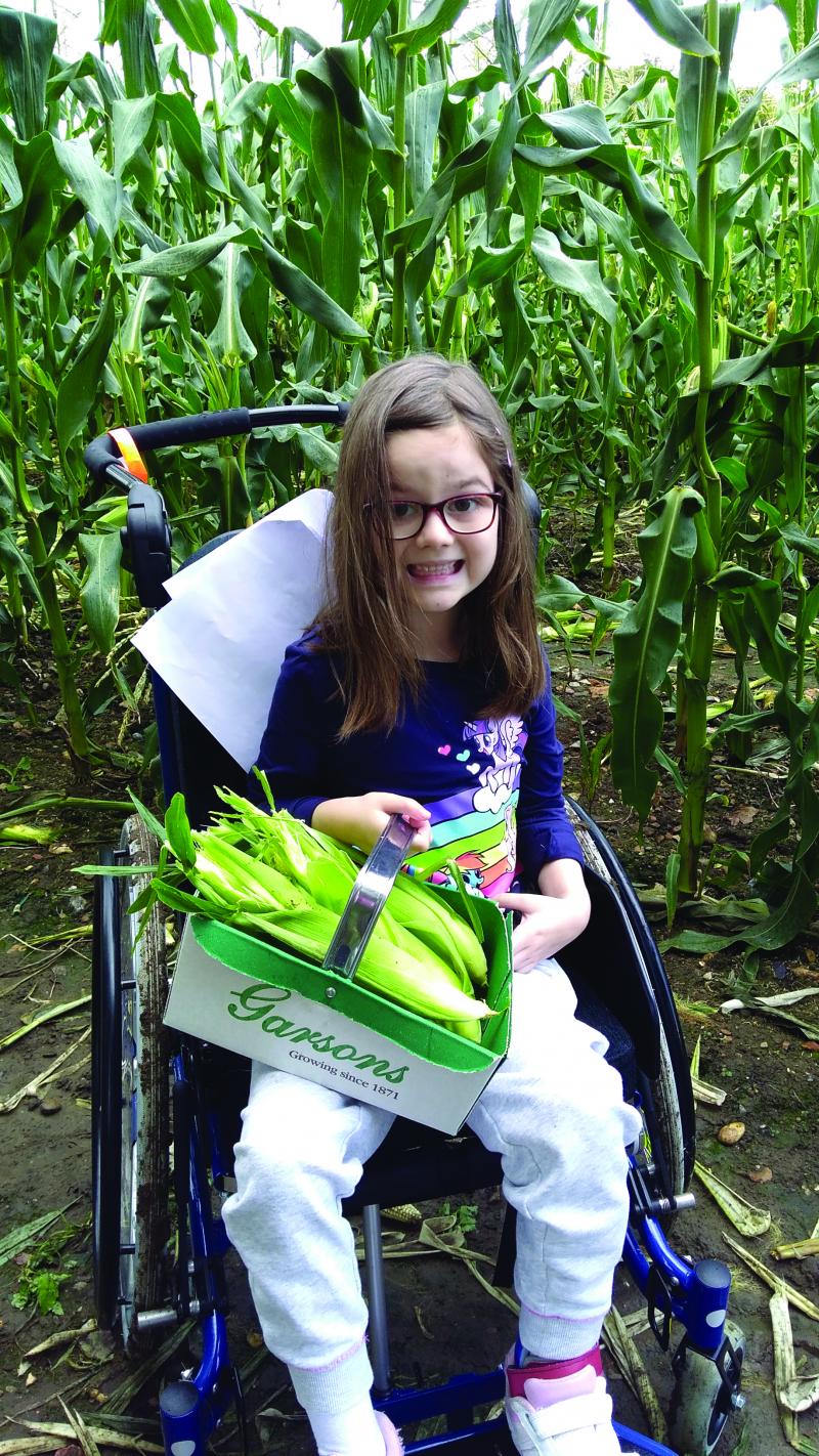 Emma at the farm picking corn