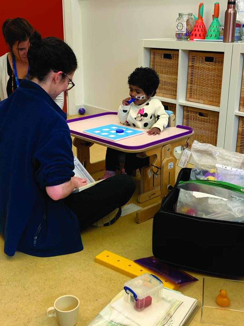 Saffron at a standing table at The Children's Trust