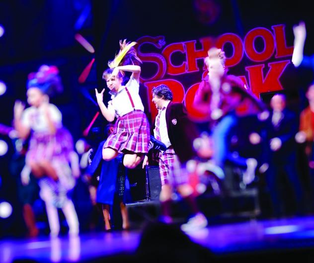 Savannah performing in School of Rock the musical