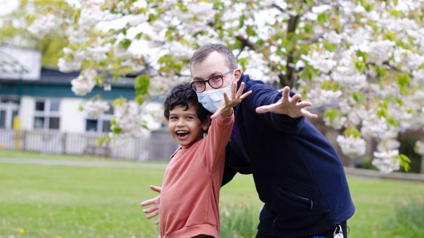 Nurse Matt stood outside at The Children's Trust posing with a young person to celebrate International Nurses Day