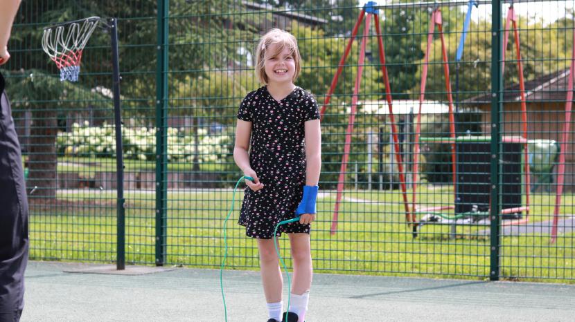 Marnie smiling at the camera holding a skipping rope