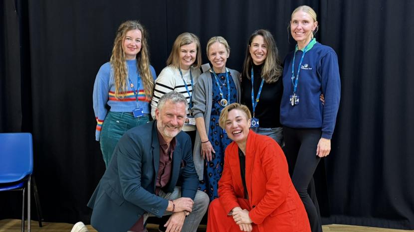 Staff, Adam Hills and Bec Hill smiling at the camera 