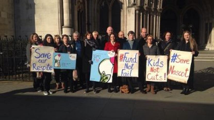 campaigners stand holding placards that read 'save our respite' and 'fund not fail' and 'kids not cutes' and 'save nascot'