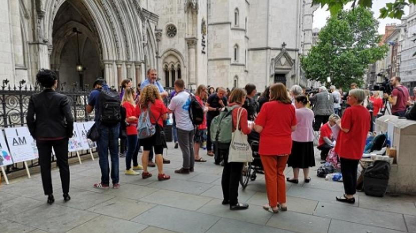 People stand around outside High Court