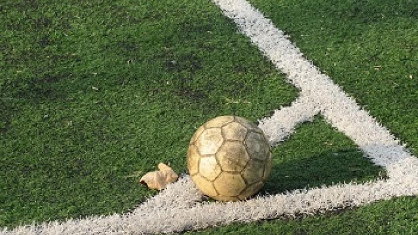 football on the corner of the pitch