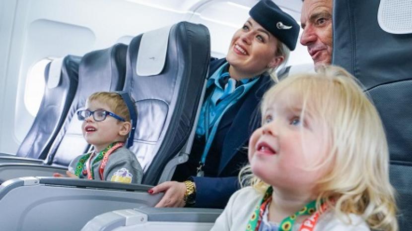 young children smile with cabin crew, image credit: Gatwick Airport