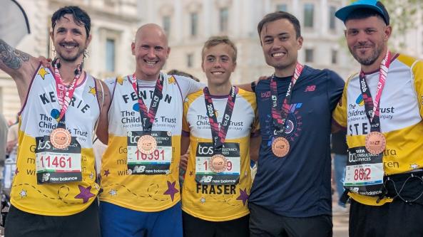 Runners with medals smiling